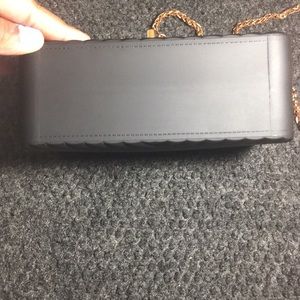 Black purse with rose gold buckle